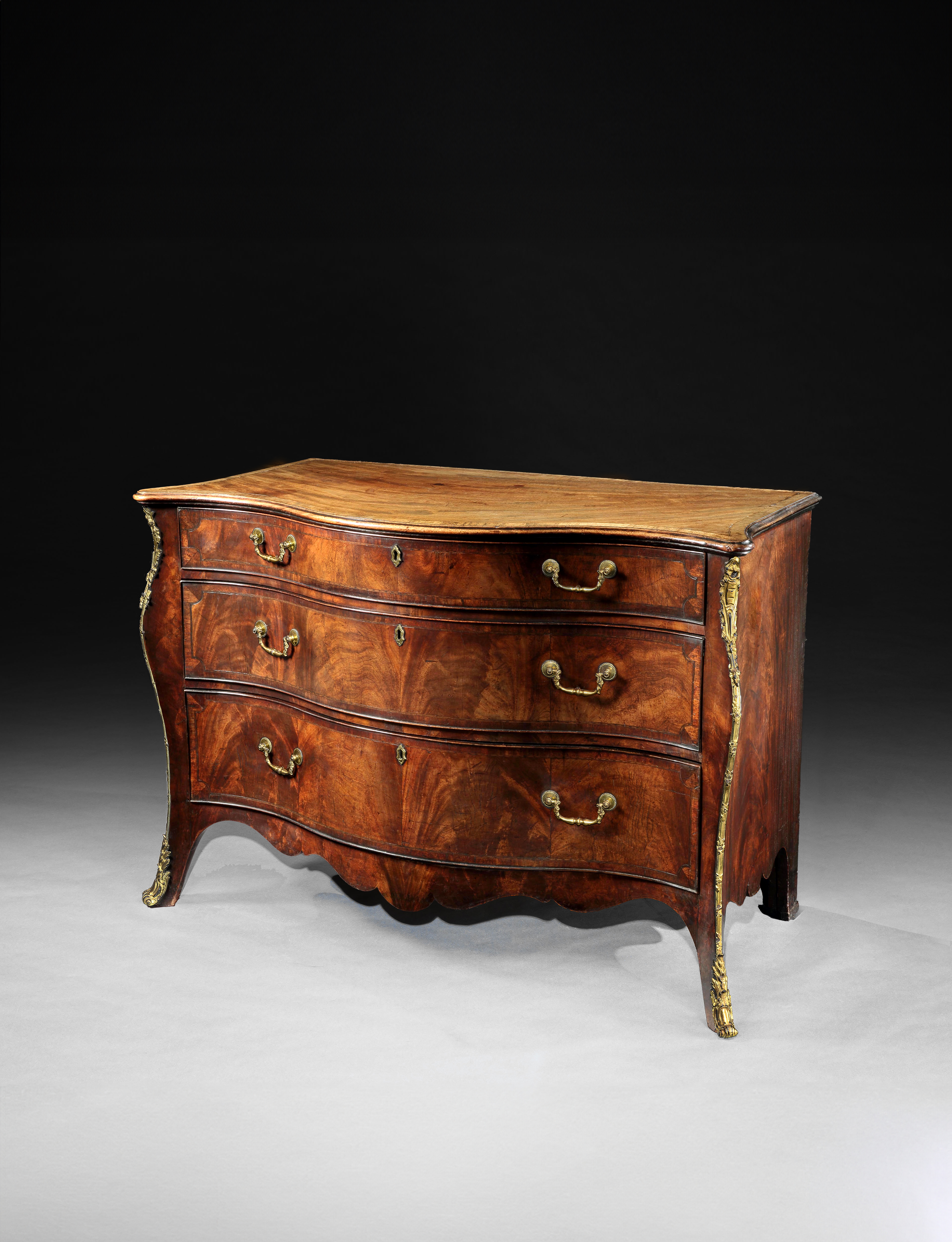 A George III period mahogany serpentine commode Attributed to Henry Hill of Marlborough
